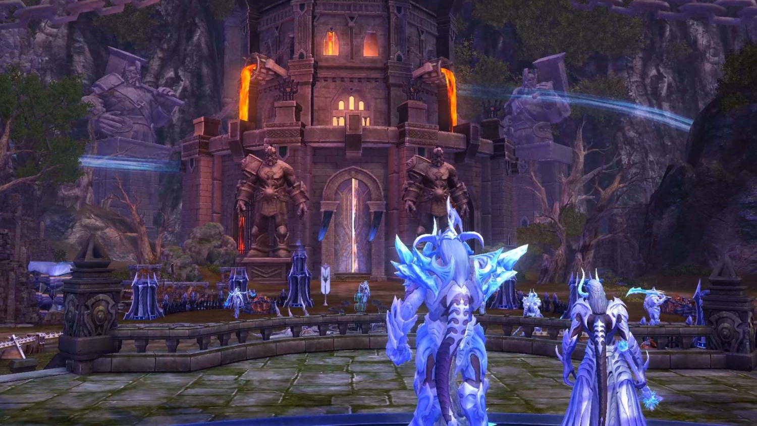 Two blue-armoured fantasy figures stand before a large stone fortress with lava pouring from its sides and giant statues