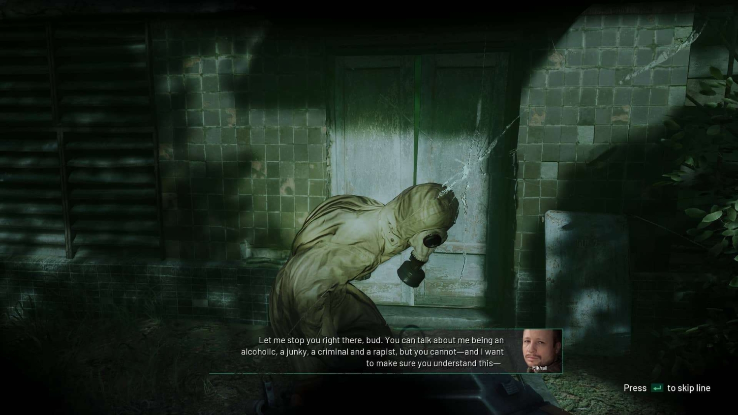 Character in a hazmat suit speaking during a tense conversation in a dark, grimy tiled room with cracked glass