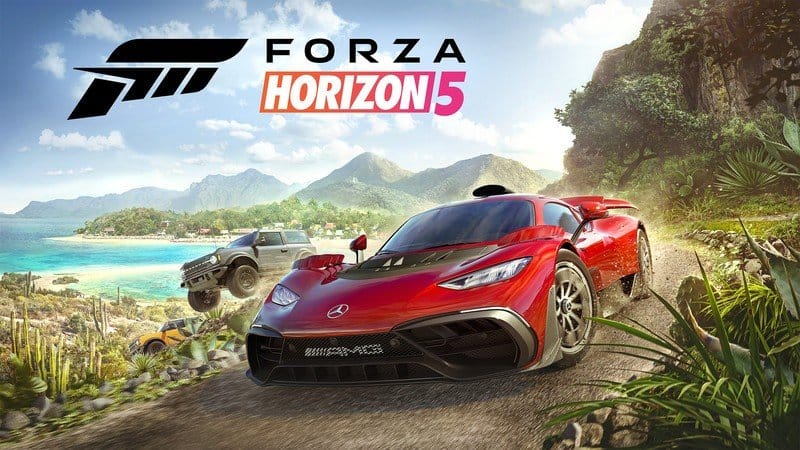 Red sports car and off-road truck racing on a dirt path near a coastal area with mountains in the background