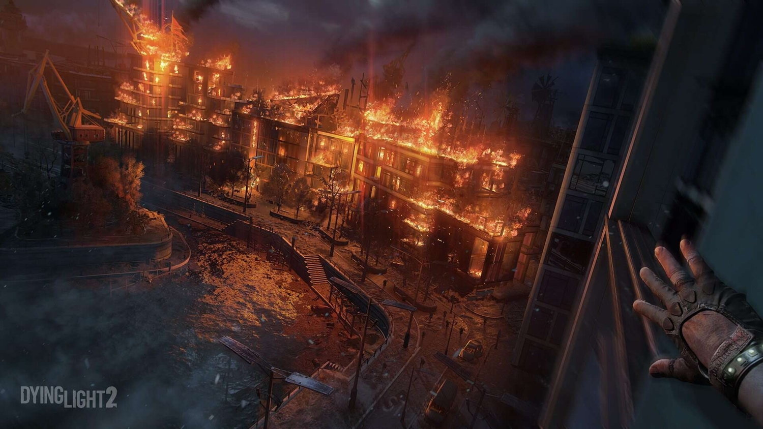 First-person perspective of a character hanging from a building overlooking a city street with buildings engulfed in fire at night