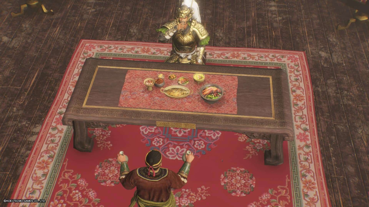 Two characters in ornate historical armour drinking tea at a wooden table with traditional dishes on a red patterned carpet