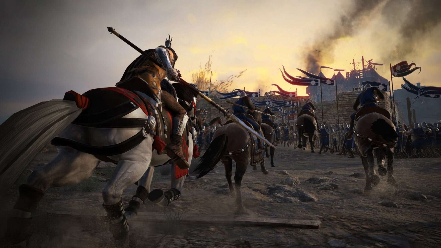 Armoured medieval knights on horseback charge towards a fortress with banners at sunset amid battle smoke