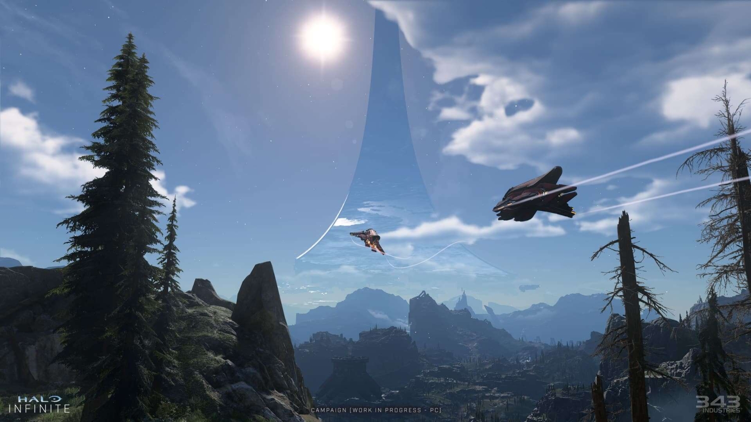 Two futuristic aircraft soar over rugged terrain with a massive ring-shaped structure in the sky under bright sunlight