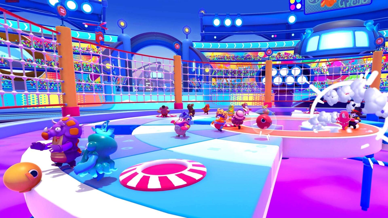 Multicoloured cartoon characters competing in a vibrant mini-game arena with a net and circular platforms