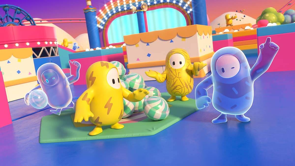 Four colourful characters in a vibrant game arena with candy-like props and festive decorations