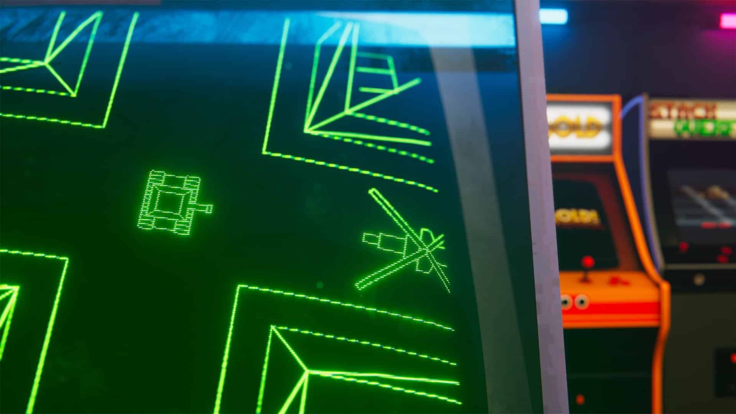 Close-up of green vector graphics game screen showing tank and geometric shapes on arcade machine