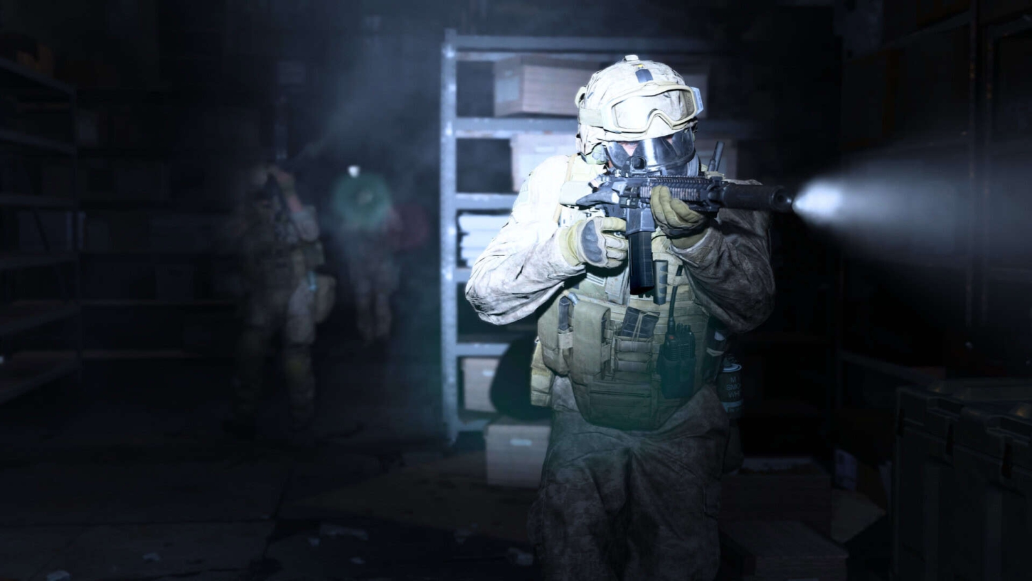 Soldier in tactical gear firing a rifle with an attached flashlight in a dark warehouse room