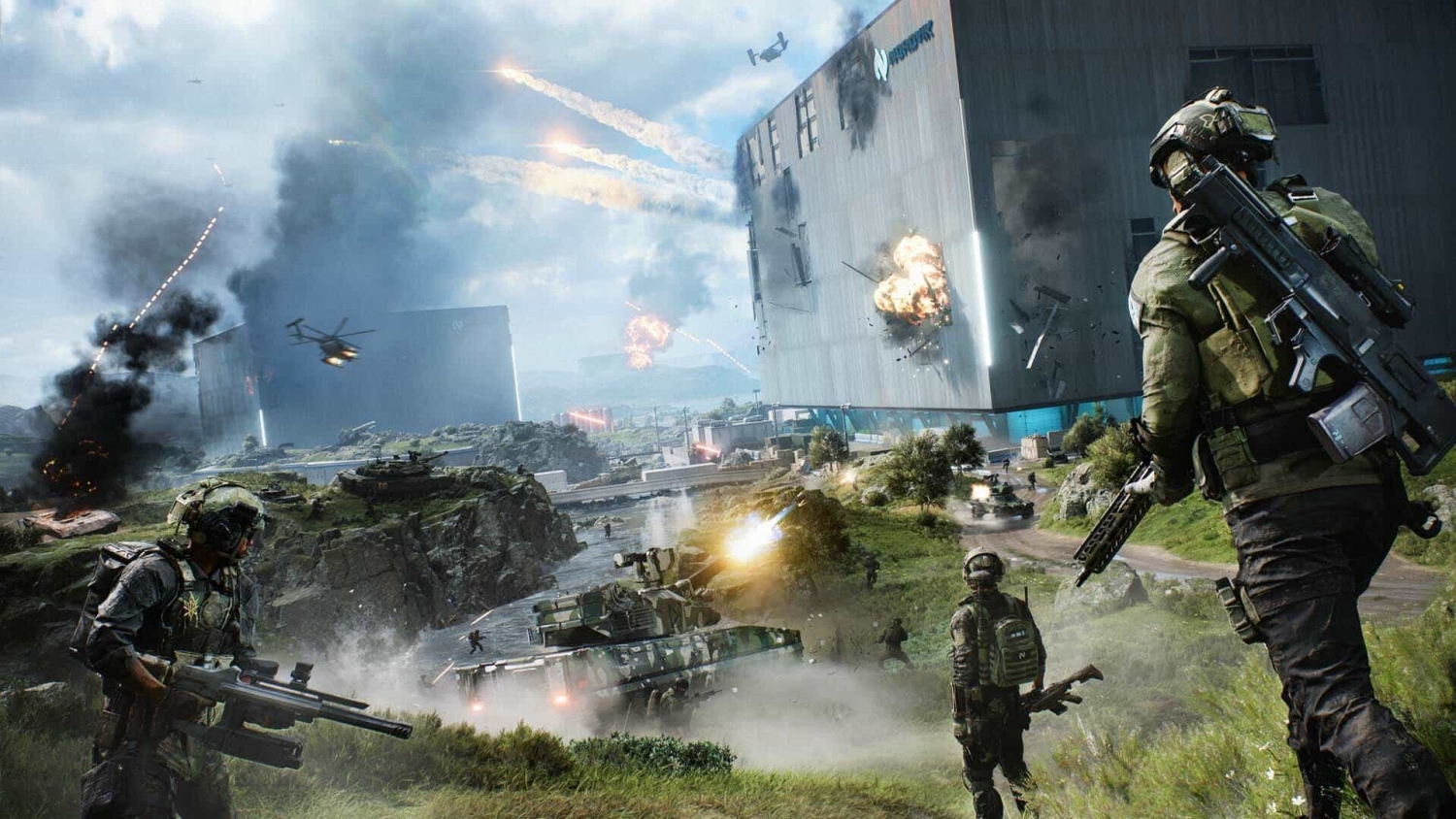 Soldiers with rifles advance across a grassy battlefield with tanks firing and helicopters overhead, explosions in the sky
