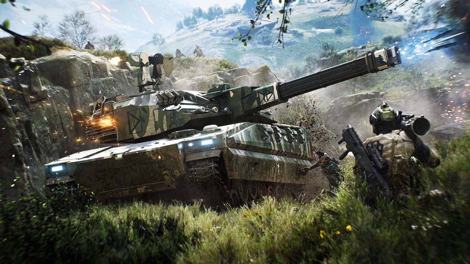 Camouflaged tank firing cannon amidst grassy terrain with soldiers advancing nearby