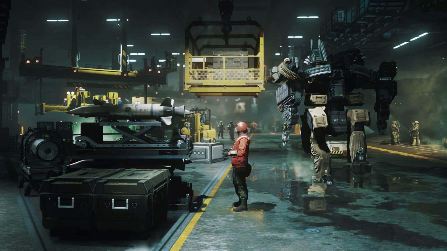Person in orange suit stands next to a missile on a platform with a large mech robot in an industrial hangar