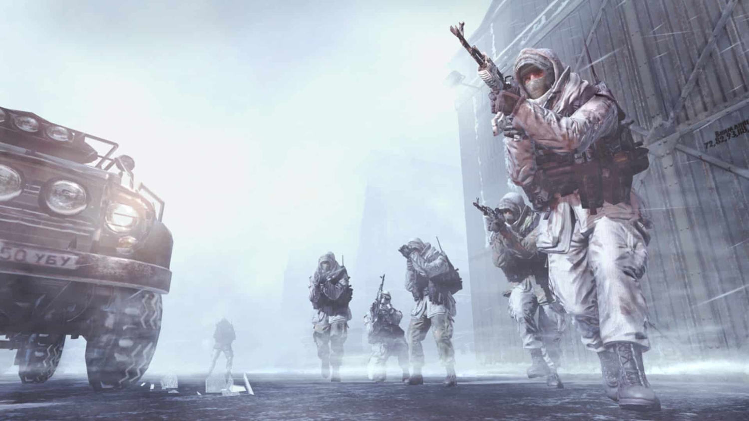Soldiers in white winter camouflage armed with rifles advancing carefully through snowy urban street