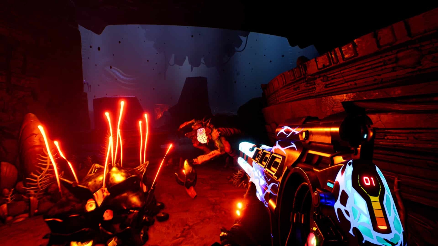 First-person perspective aiming a neon-lit futuristic gun at alien creatures in a dark cavern environment