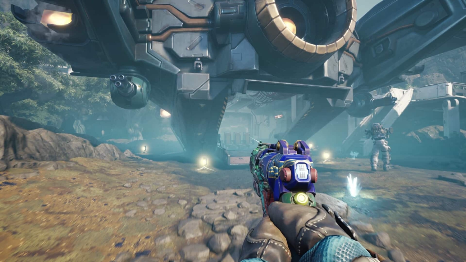 Player holding a colourful futuristic weapon aiming at a large spaceship under landing gear in a sci-fi setting