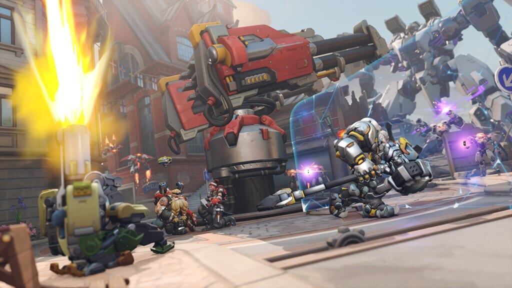 Multiple characters engaged in combat near a large robotic turret in a city square in Overwatch 2
