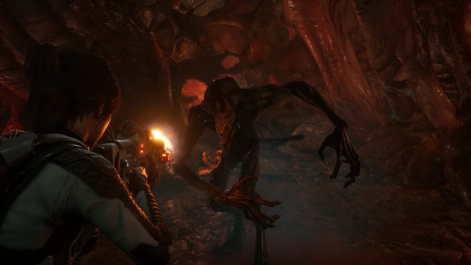 Character with dark hair firing a rifle at a grotesque creature with elongated arms in a dark, wet cavern