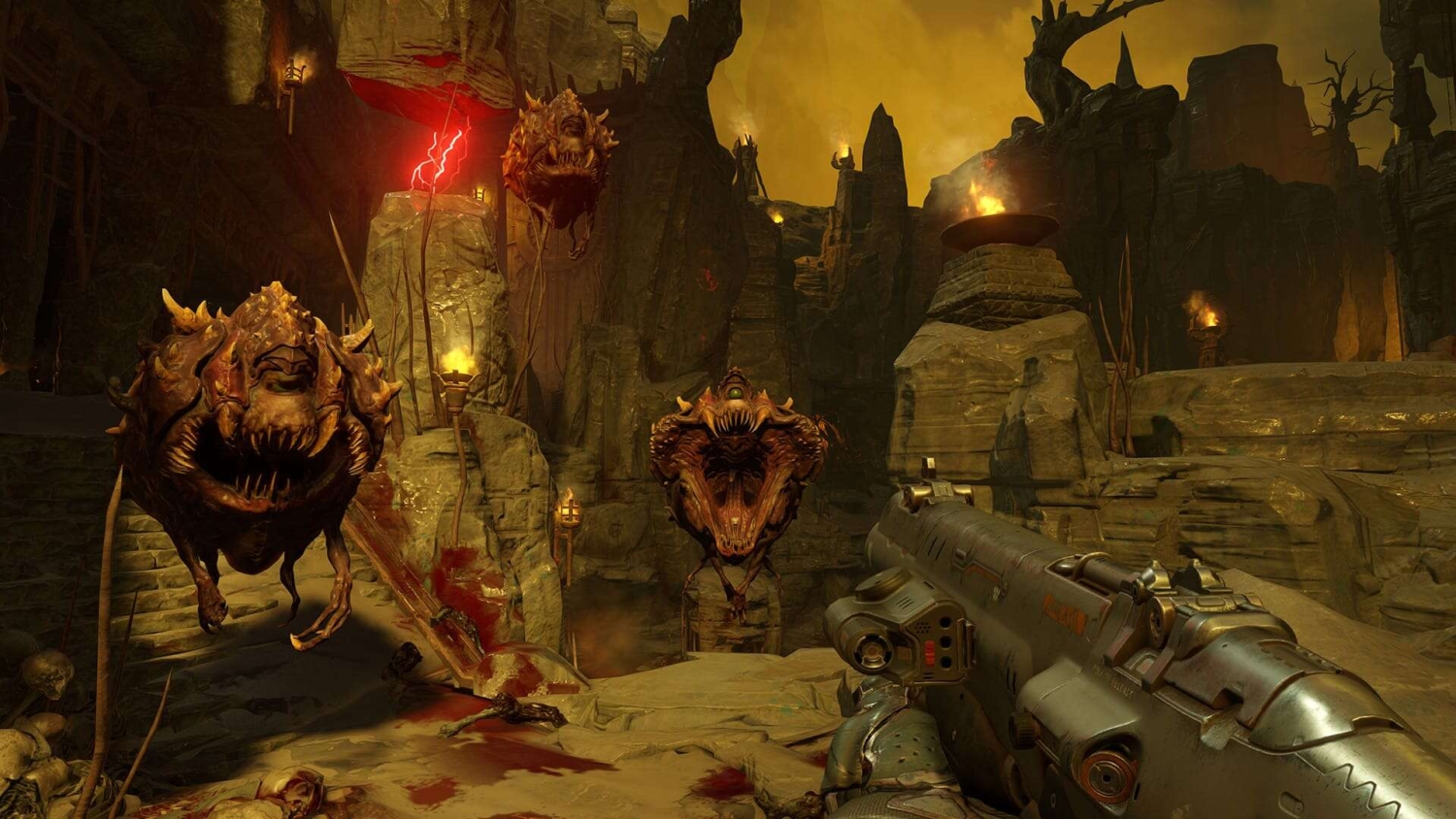 First-person view of a shotgun targeting two flying demonic creatures in a fiery, rocky hellish landscape