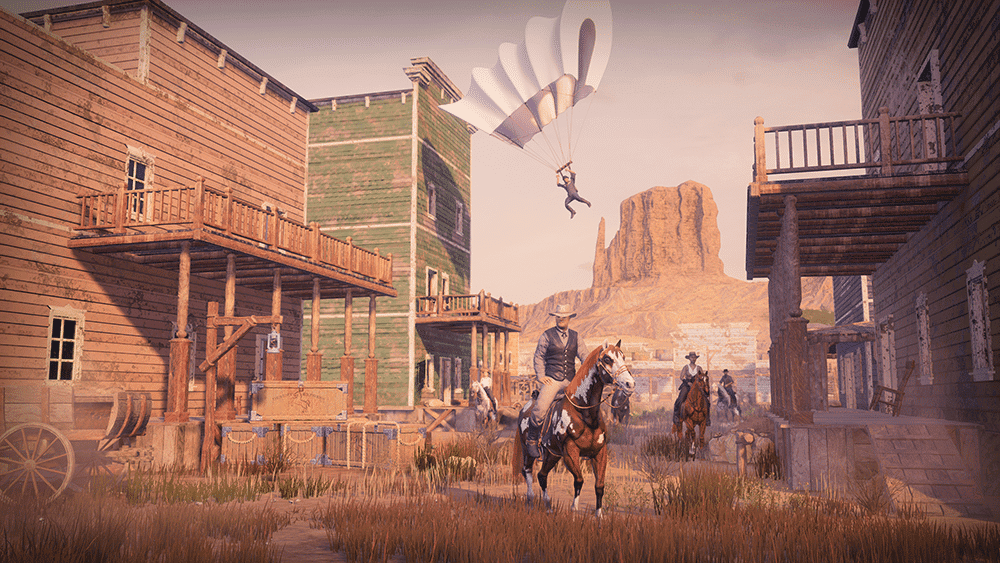 Man riding a horse in a dusty western town with a parachutist descending in the background