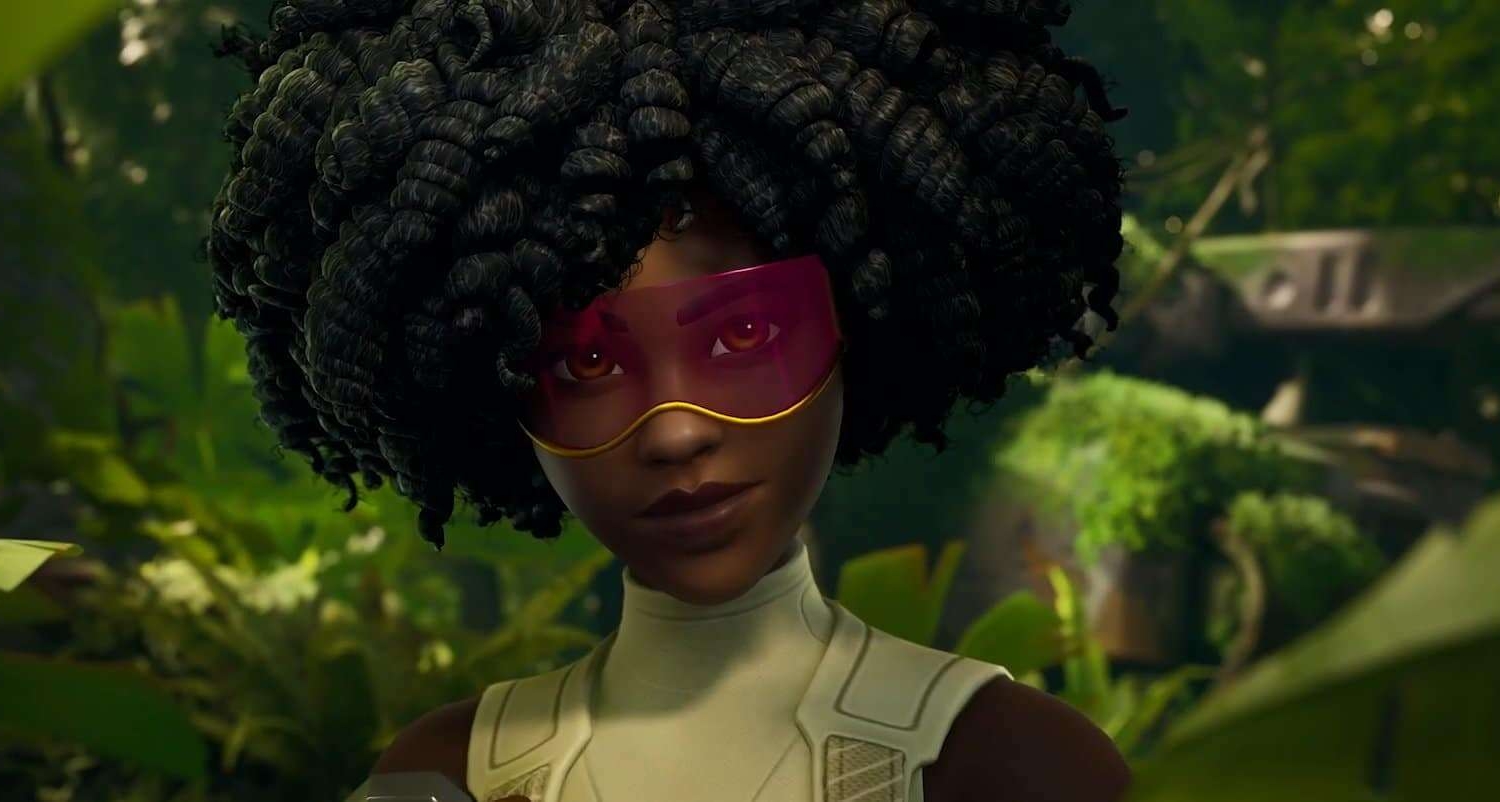 Woman with voluminous curly hair and purple visor standing in dense green foliage