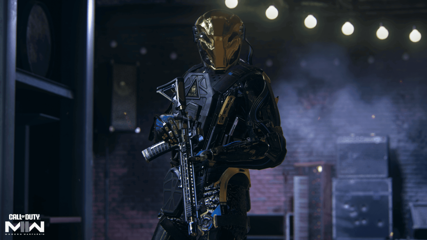 Armoured figure in black and gold futuristic tactical suit holding a rifle in a dimly lit indoor setting