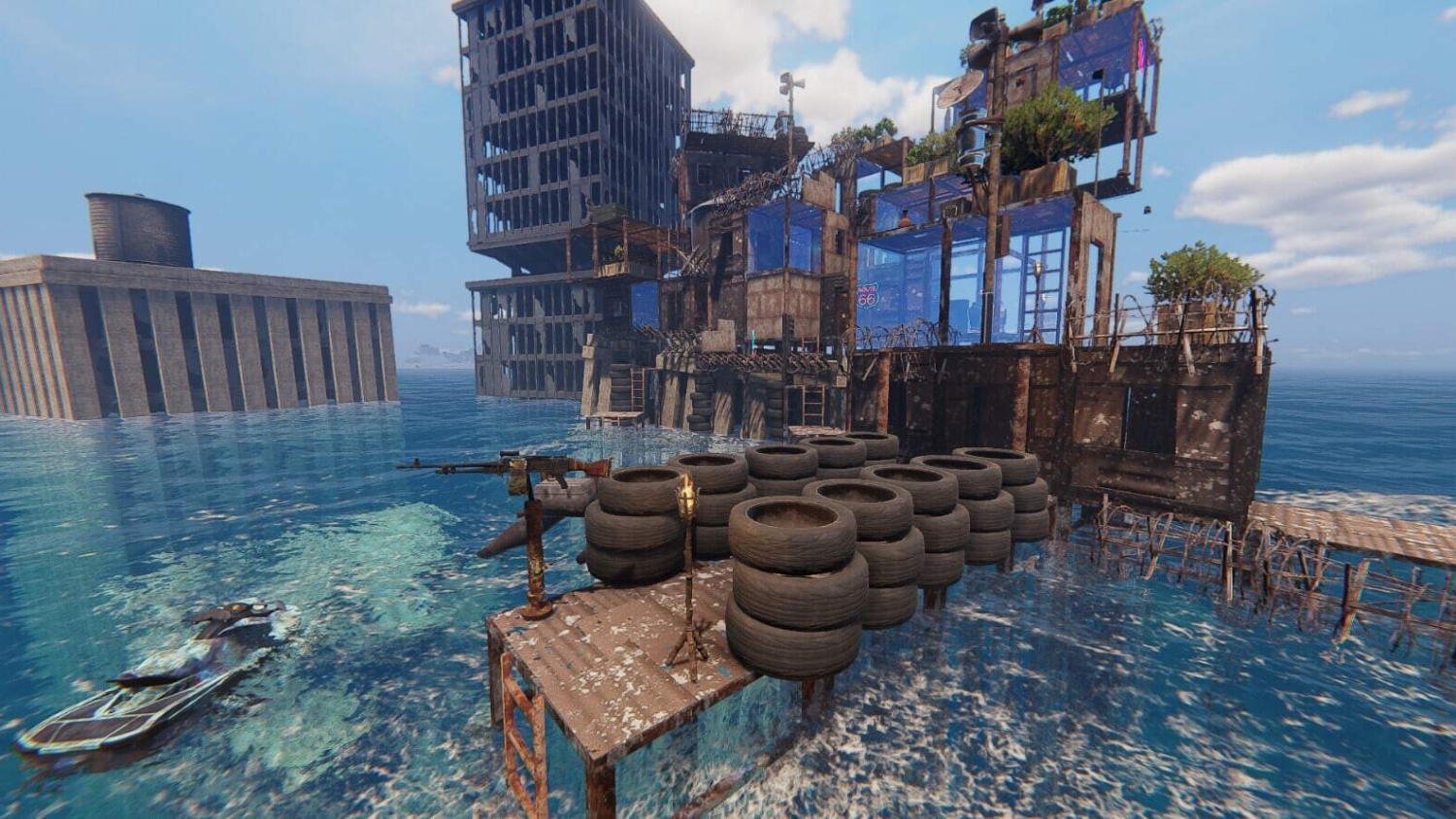 Rusty multi-level structure on stilts surrounded by clear water with stacked tyres on platform and submerged boat nearby
