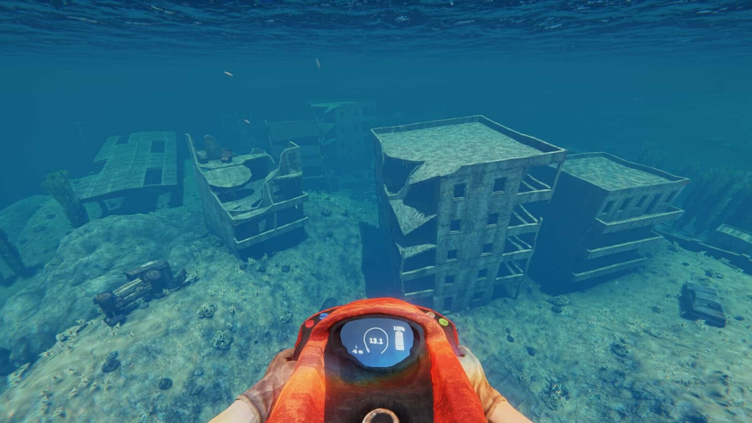 First-person view holding orange diving equipment above sunken, dilapidated buildings underwater