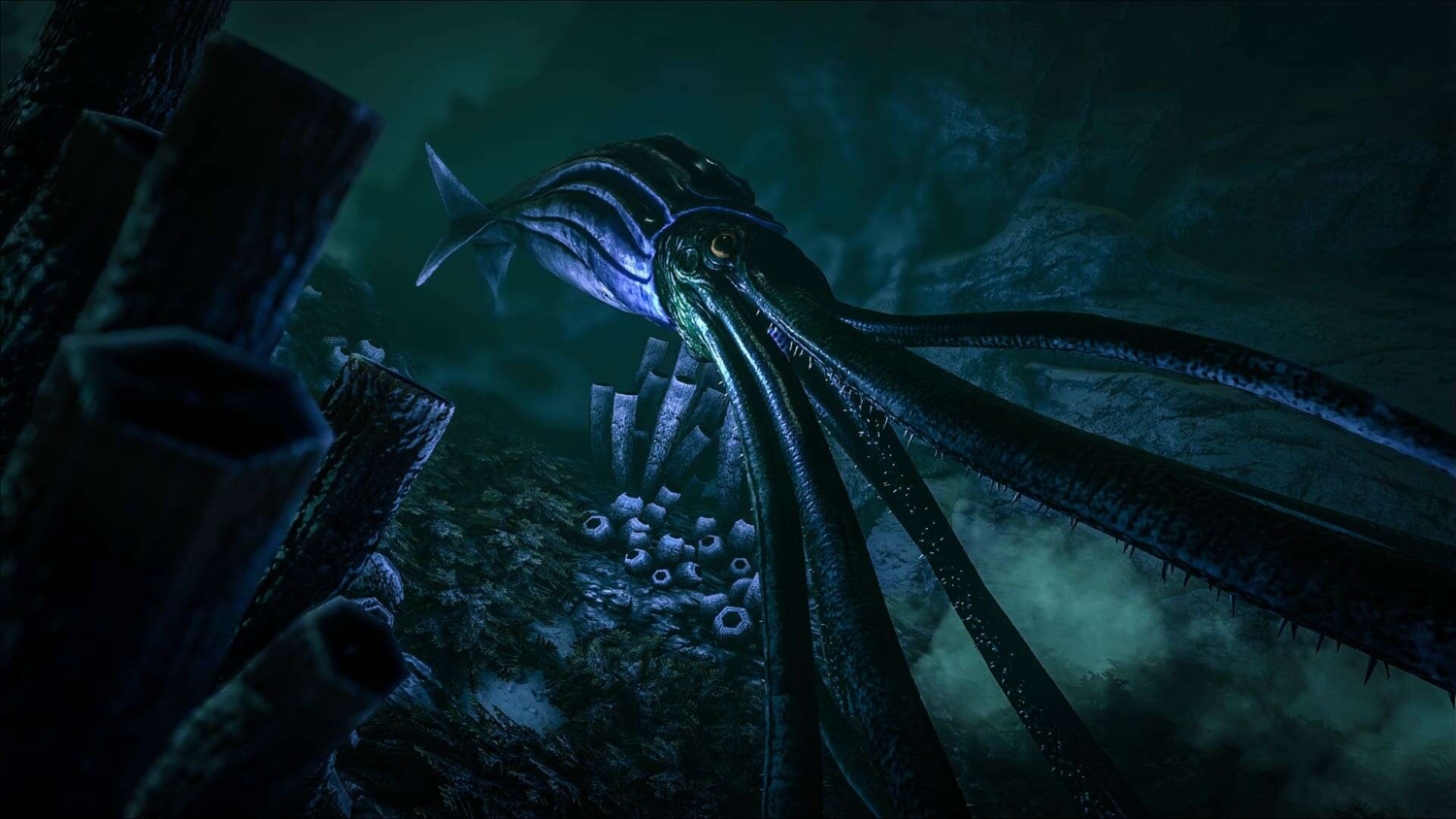 Large blue squid with elongated tentacles in a dark underwater cave environment