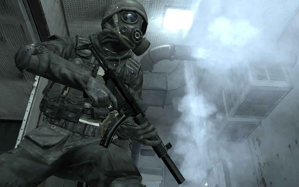 Soldier in tactical gear and gas mask holding a rifle amid smoke in an industrial corridor