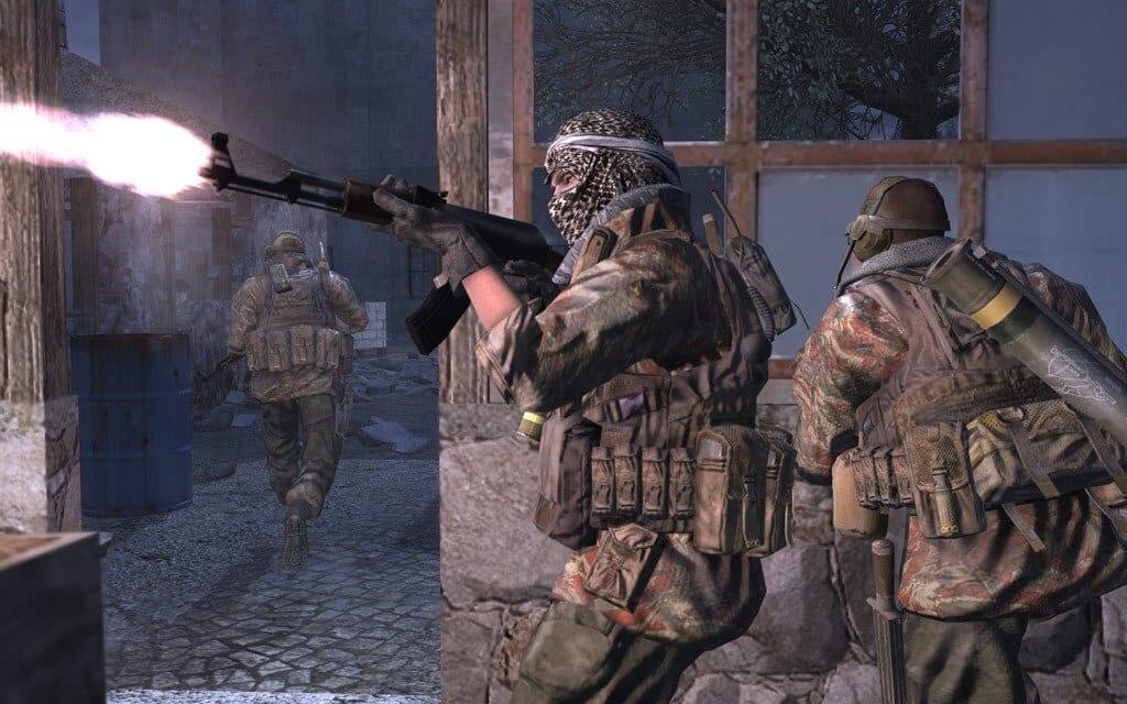 Three soldiers in camouflage gear firing weapons and moving through a damaged urban building at night