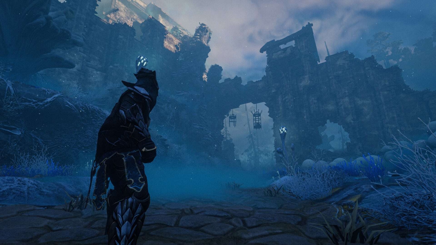 Figure in dark armour casting glowing spell near ancient ruined stone gate in misty blue atmosphere