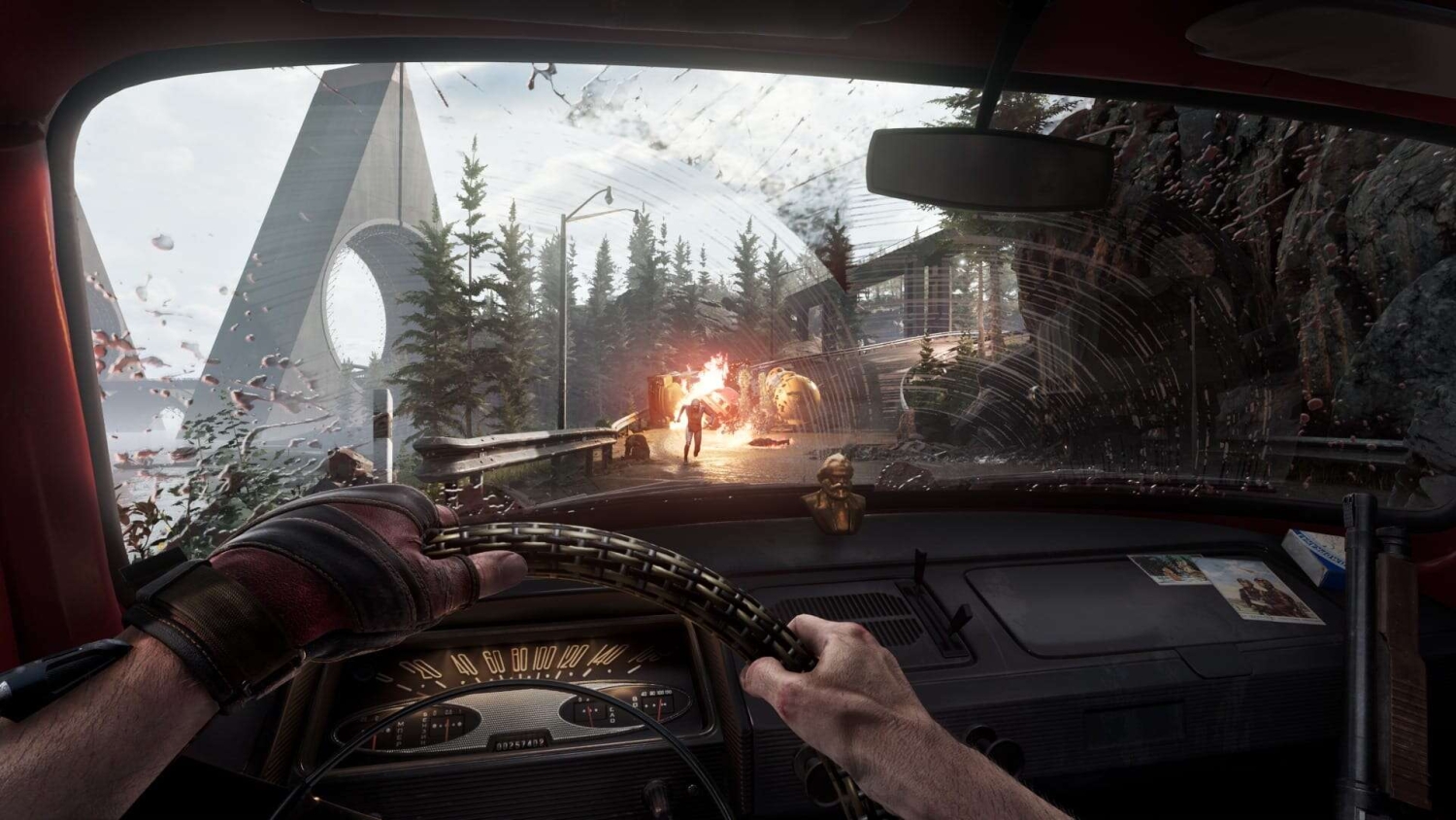 First-person driving view with gloved hands on steering wheel, figure fleeing an explosion on snowy cracked road ahead
