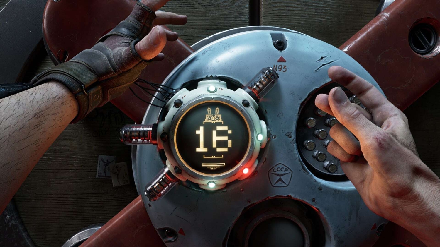 Hands interacting with a circular sci-fi mechanical device showing a pixelated robot and number 16