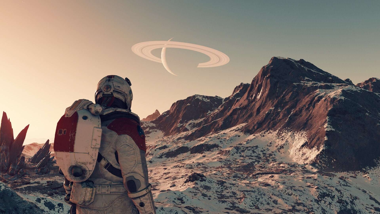 Astronaut in white and red spacesuit stands on snowy rocky landscape with ringed planet in sky