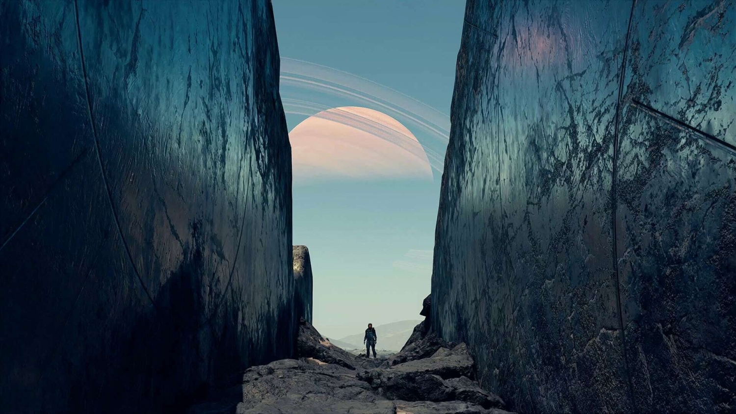 A lone figure stands between towering rocky cliffs under a sky featuring a large ringed planet