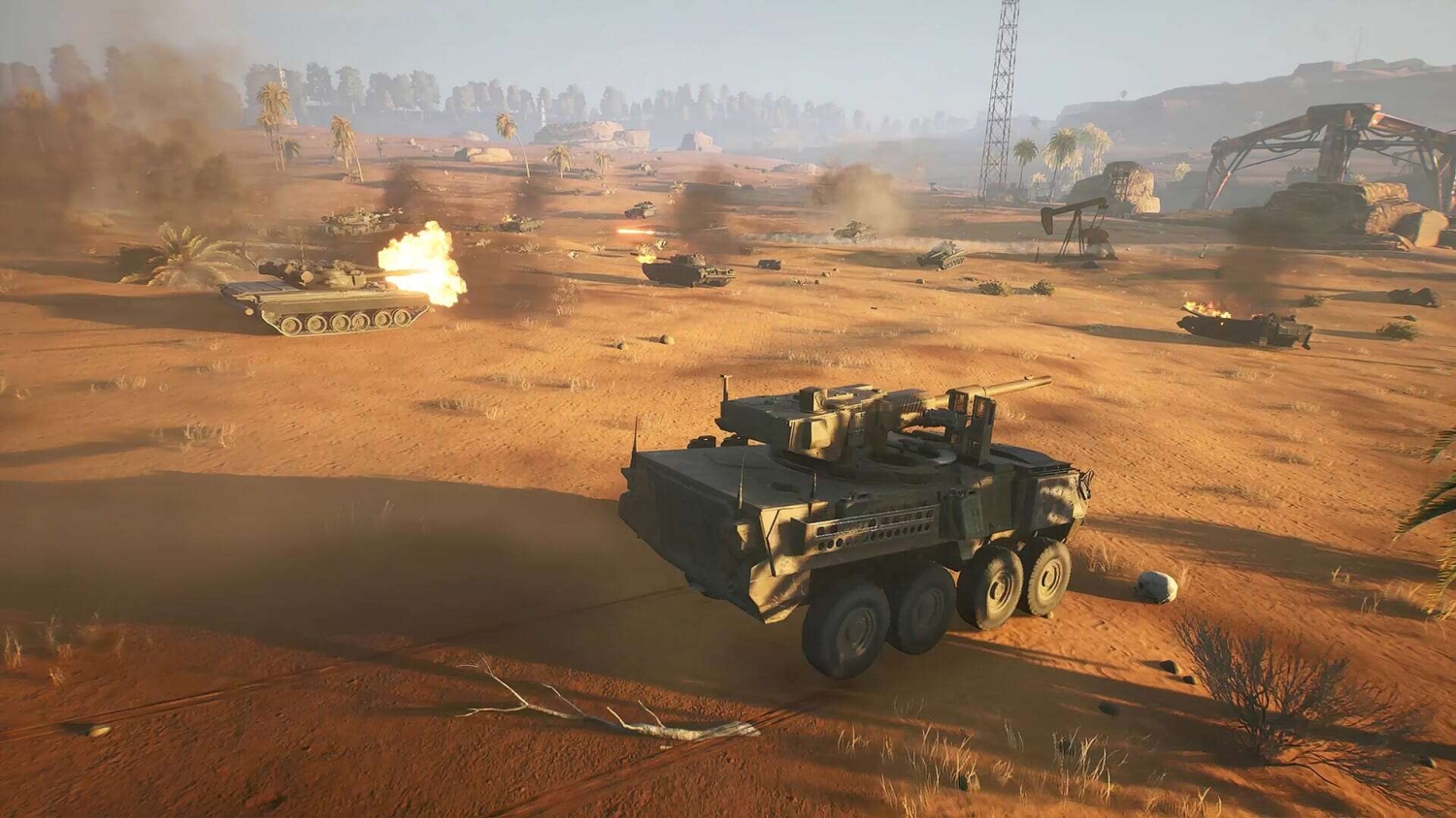 Armoured vehicles and tanks firing across a desert battlefield with smoke and explosions visible