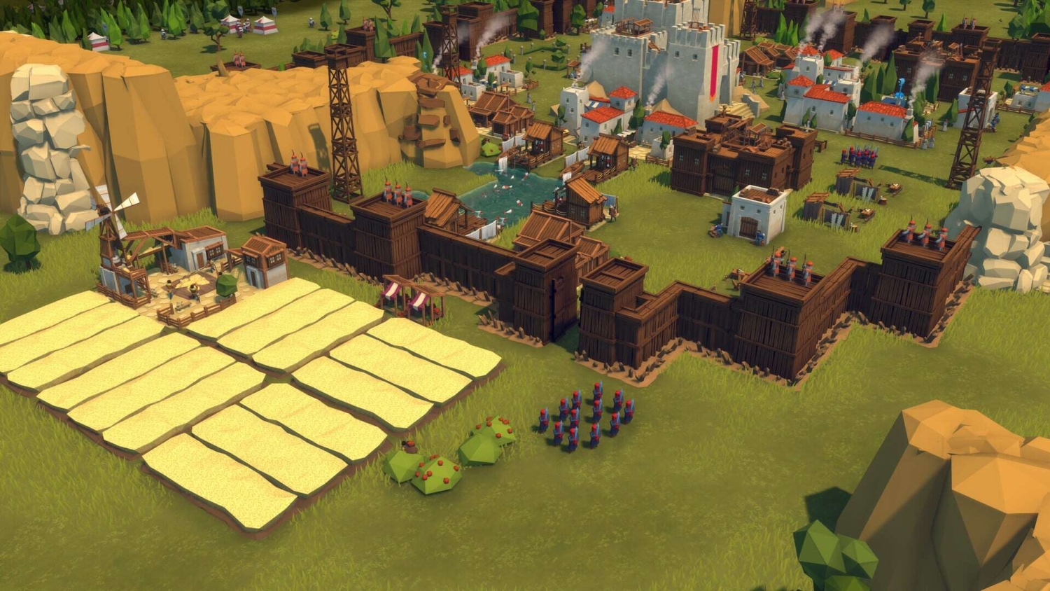 A medieval-style settlement with wooden walls, small farms, soldiers in red and blue uniforms, and white stone buildings with smoke rising