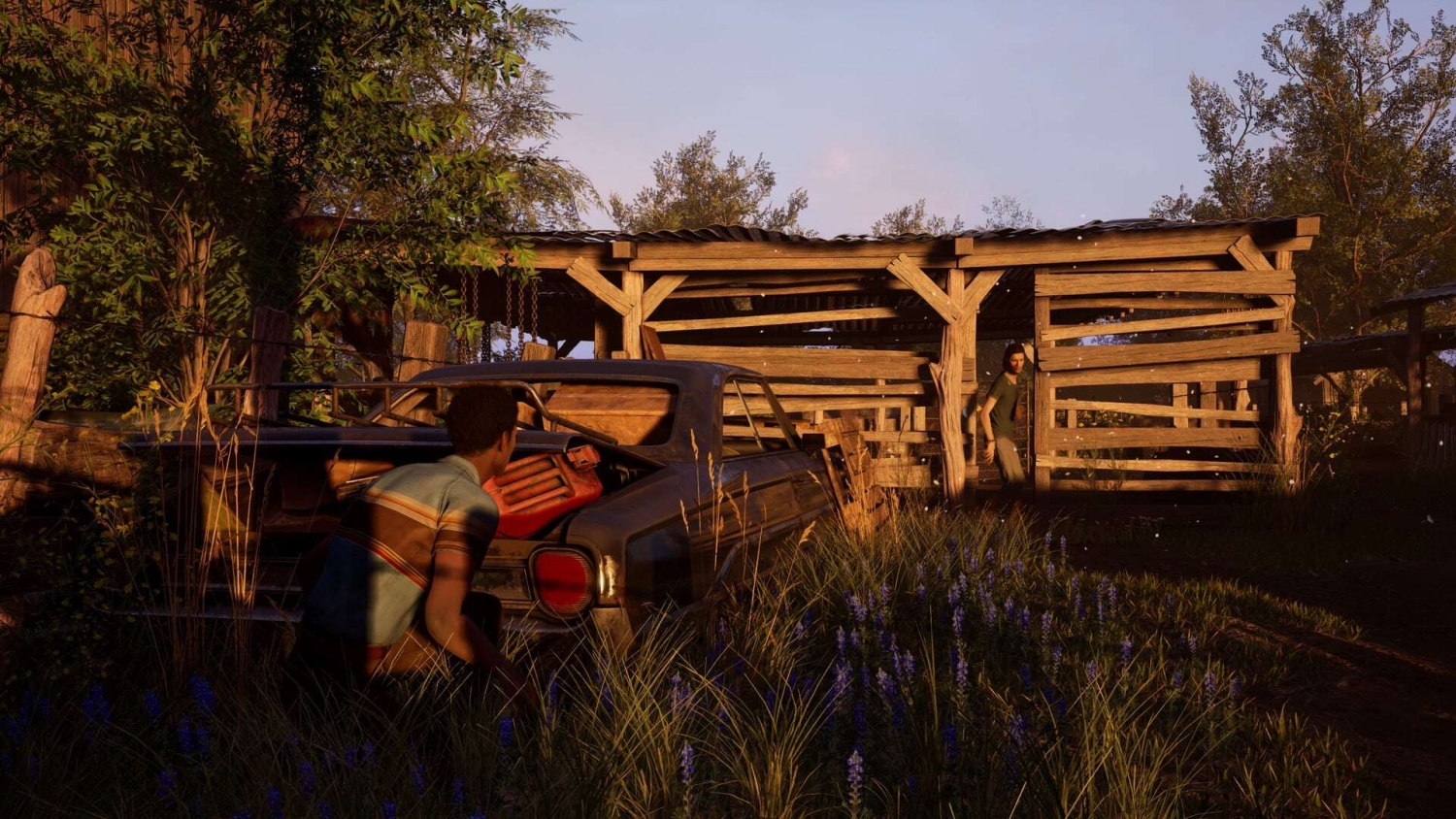 Two characters in a rustic yard at sunset, one crouched behind a car and another standing near a wooden shed