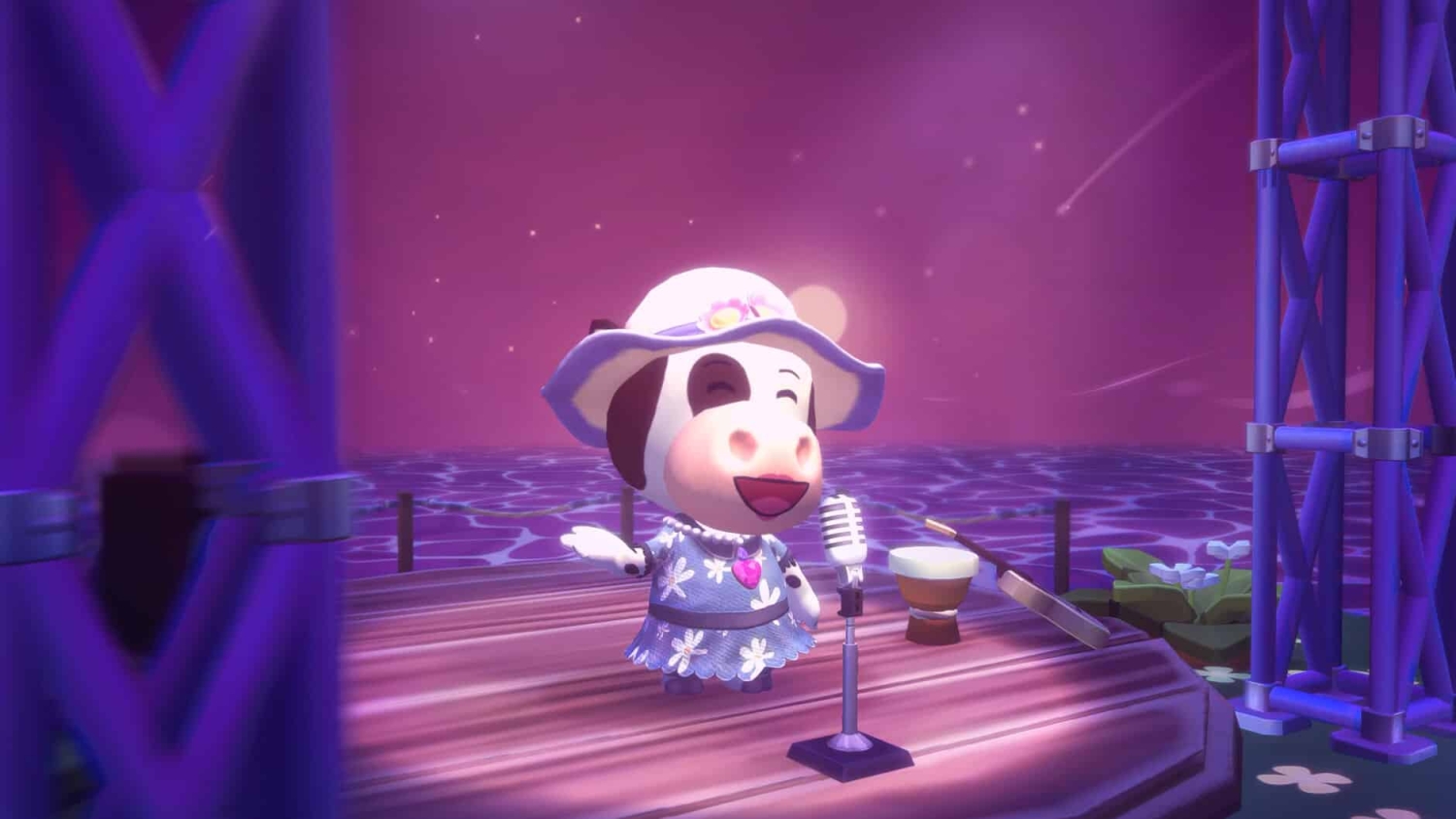 Animated cow character in a blue floral dress and white hat singing on wooden stage with microphone