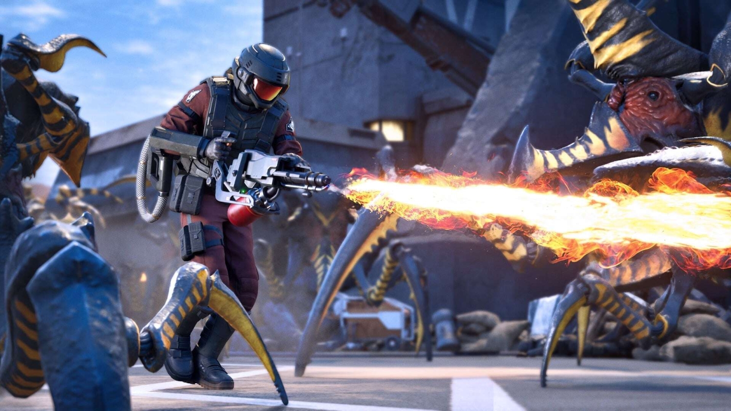 Armoured soldier fires a flamethrower at large insect-like alien creatures in an industrial environment