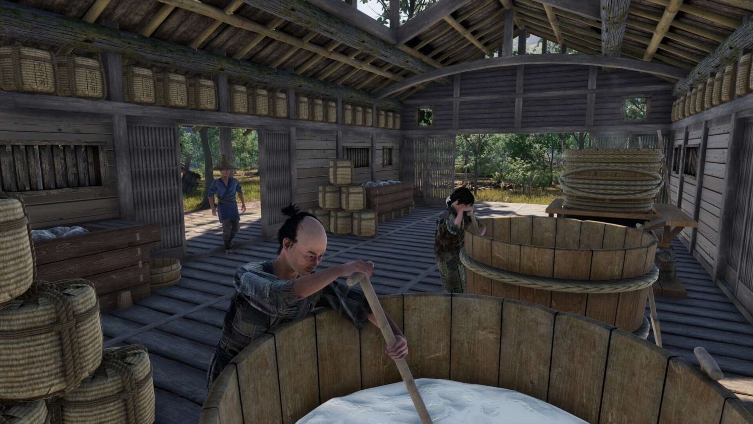Characters working inside a wooden building with large wooden vats and woven baskets for fermentation