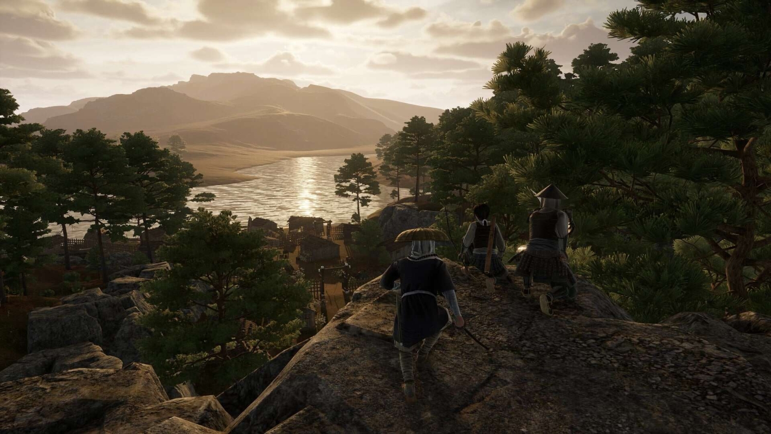 Three characters in traditional historical clothing crouch on a rocky hill, overlooking a village by a river with trees and mountains at sunset