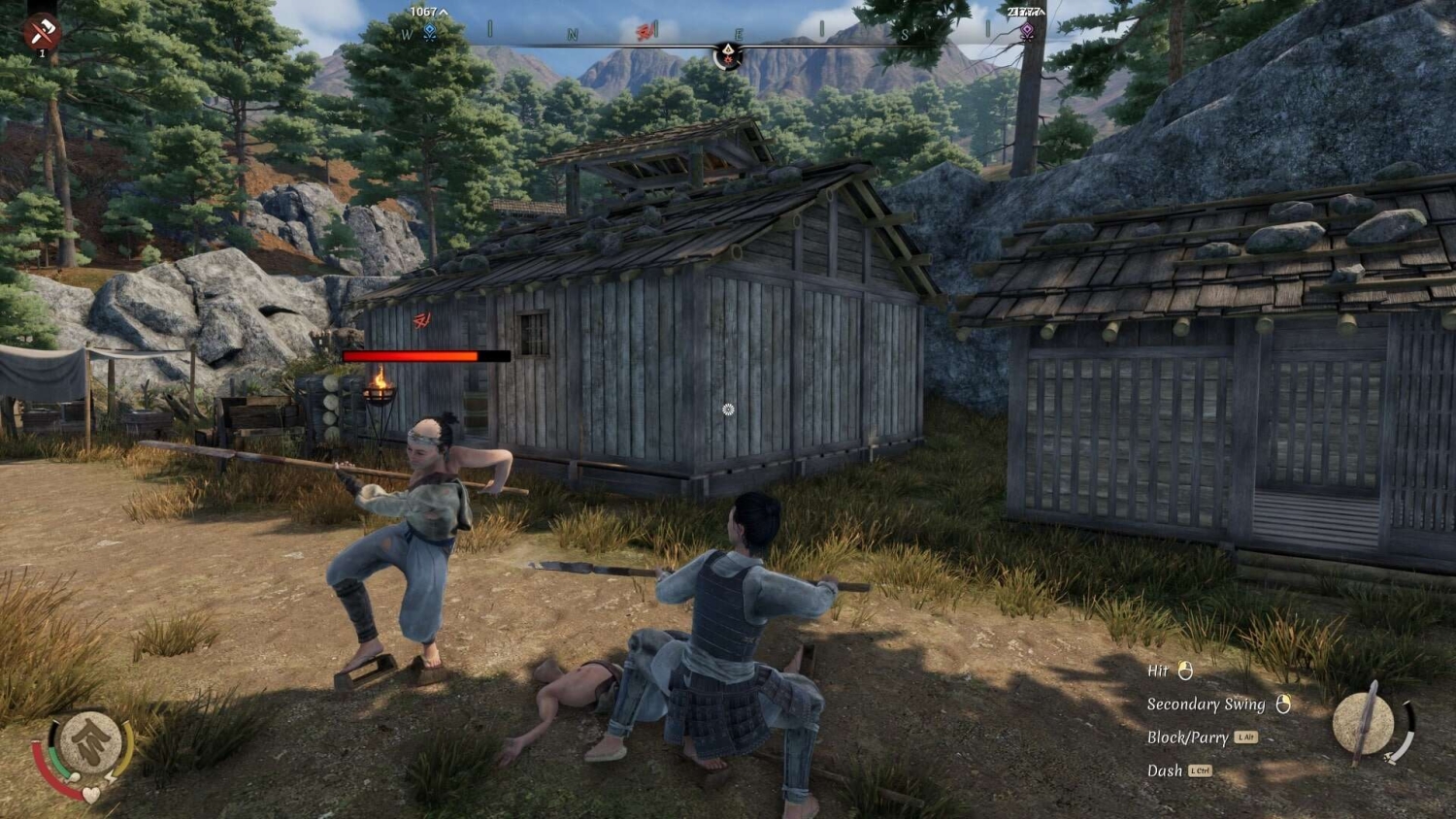 Two armed characters engage in spear combat outside wooden houses in a forested village setting