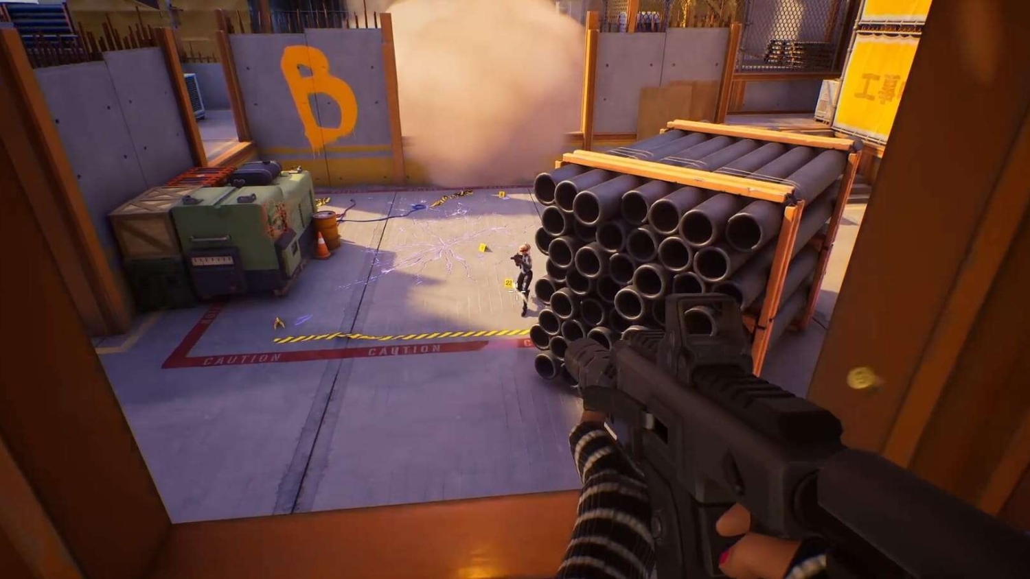 First-person shooter view targeting an enemy standing beside stacked pipes and a wall with a large orange letter B