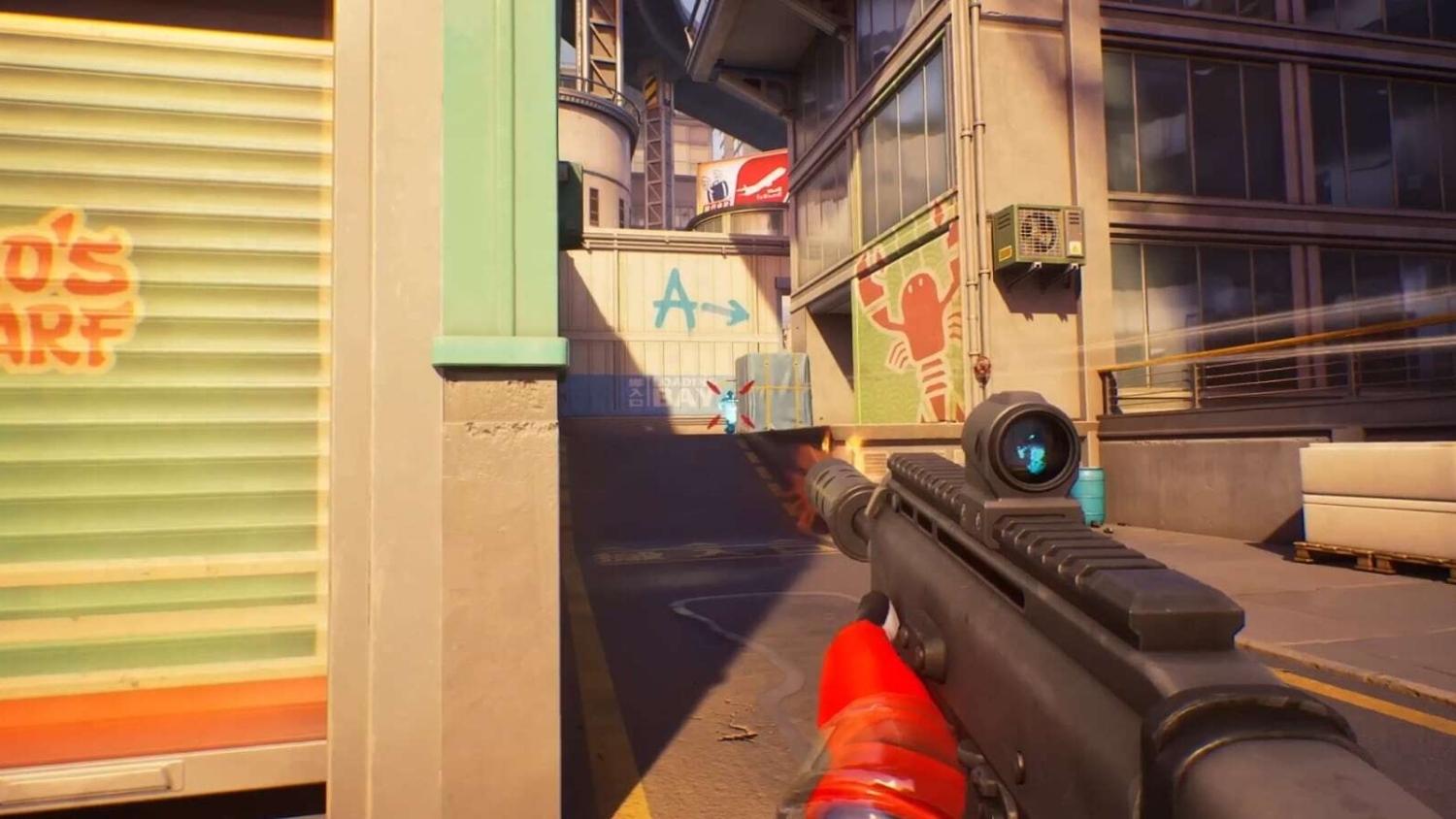 First-person view of a character aiming and firing a gun in a sunlit urban environment with warehouses and colourful graffiti