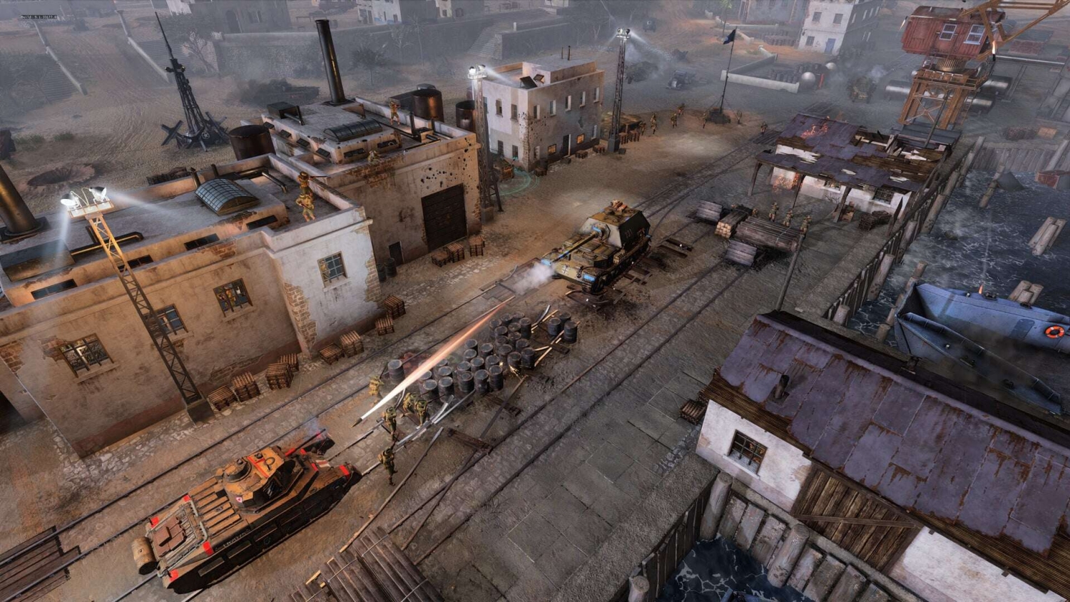 Two tanks engage in battle firing at soldiers near warehouses and docks on coastal railway tracks
