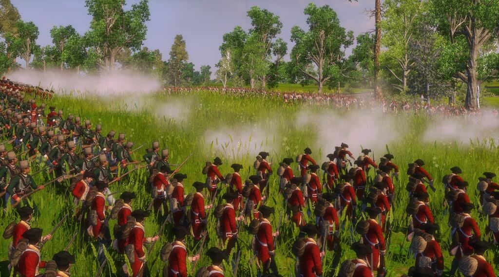 Soldiers in red coats firing muskets across a grassy battlefield with smoke and trees around