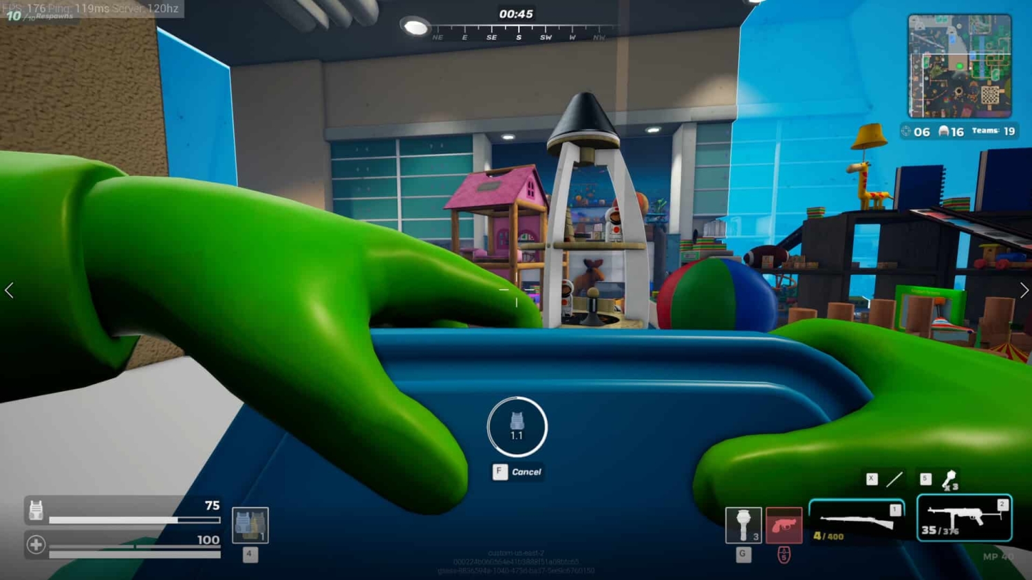 Green-gloved hands hold a blue toy container in a colourful indoor playroom setting with toys and play structures