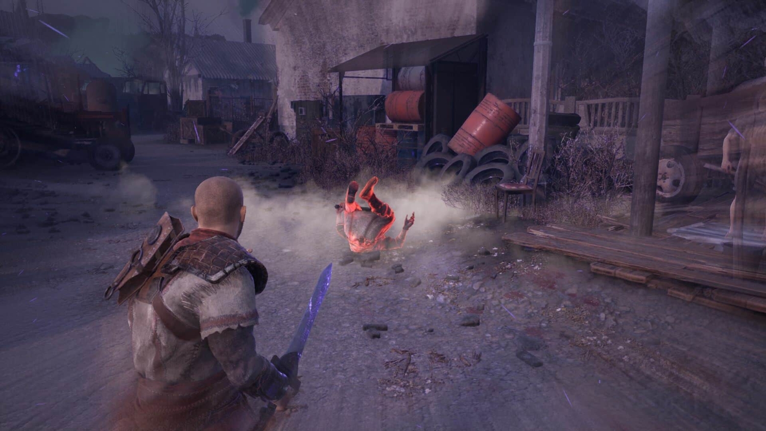 Character holding a glowing sword facing an enemy thrown backwards on a rough industrial street