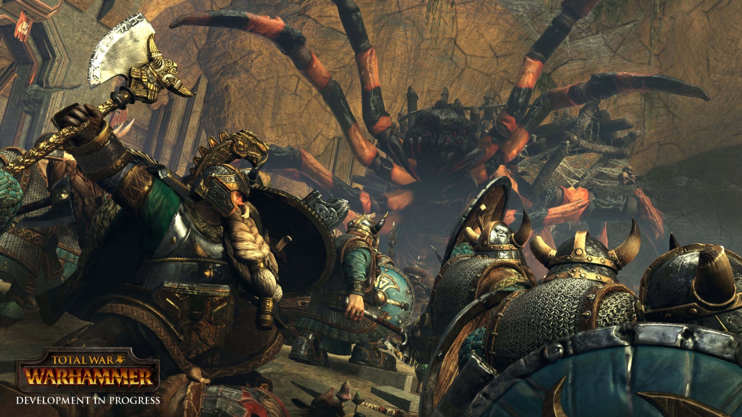 Armoured fantasy warriors wield weapons and shields fighting a huge spider in a dim cavern