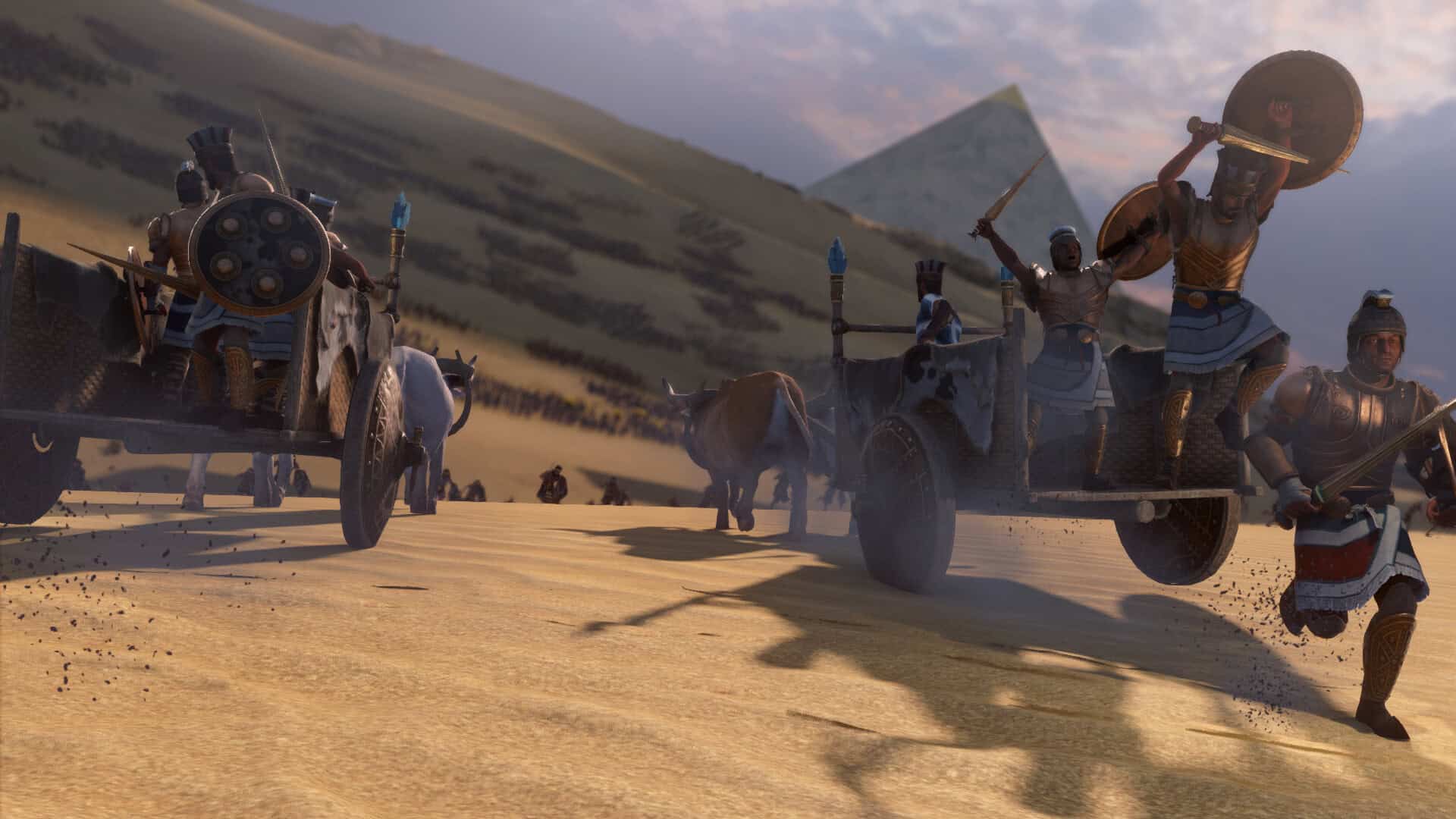 Armoured ancient Egyptian charioteers charging across desert sand near pyramids at sunset